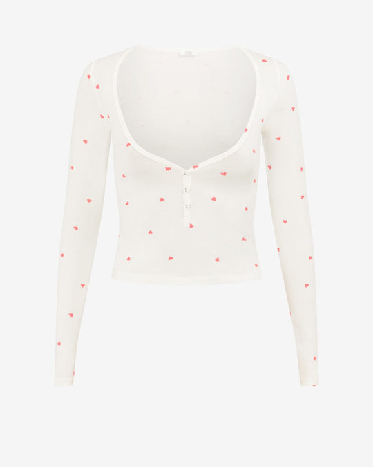 Hip length long sleeve top in limited edition love heart print, low sweetheart neckline with button closure, fits true to size, form fitting, made from buttery soft modal blend